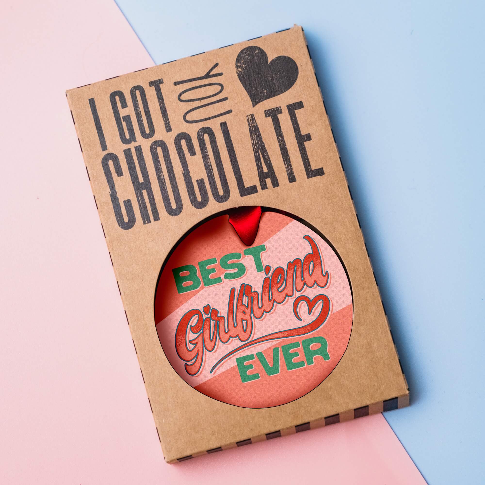 Best Girlfriend Ever milk chocolate medal presented in plastic-free “I got you chocolate” gift packaging on a pastel background.