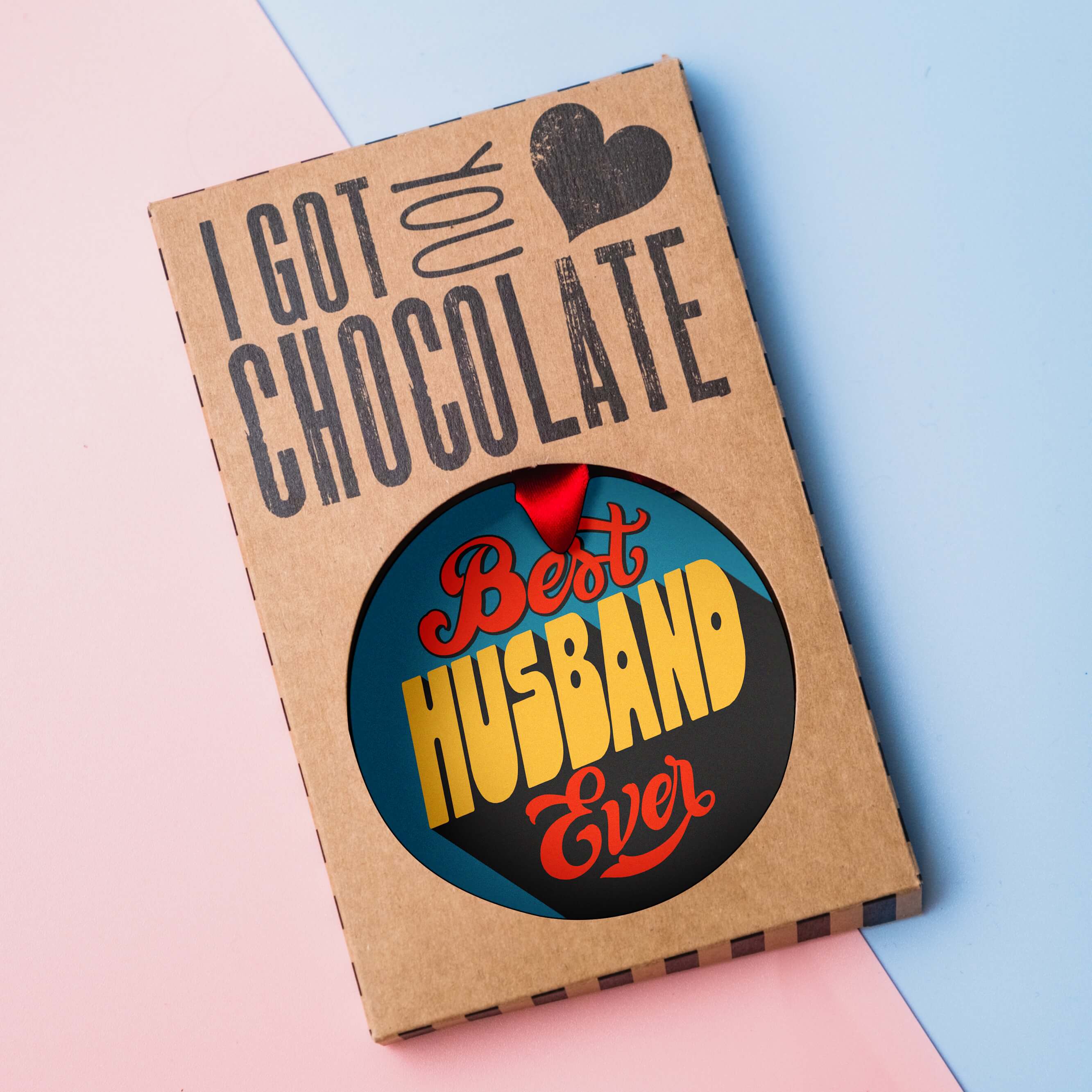 Best Husband Ever milk chocolate medal presented in plastic-free “I got you chocolate” gift packaging on a pastel background.