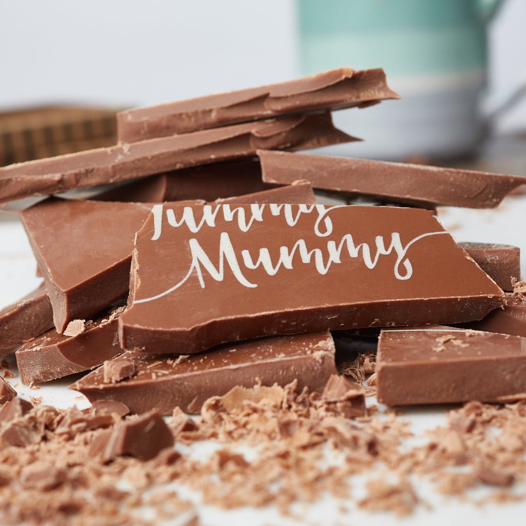 Close up of broken chunky pieces of the 'Yummy Mummy' milk chocolate bar