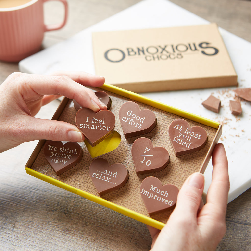 Selection of funny chocolate hearts with cheeky messages for your teacher, presented in an Obnoxious Chocs gift box