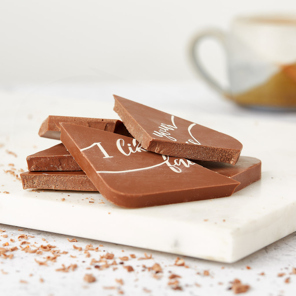 'I like your face' chocolate bar broken into pieces to show solid milk chocolate centre