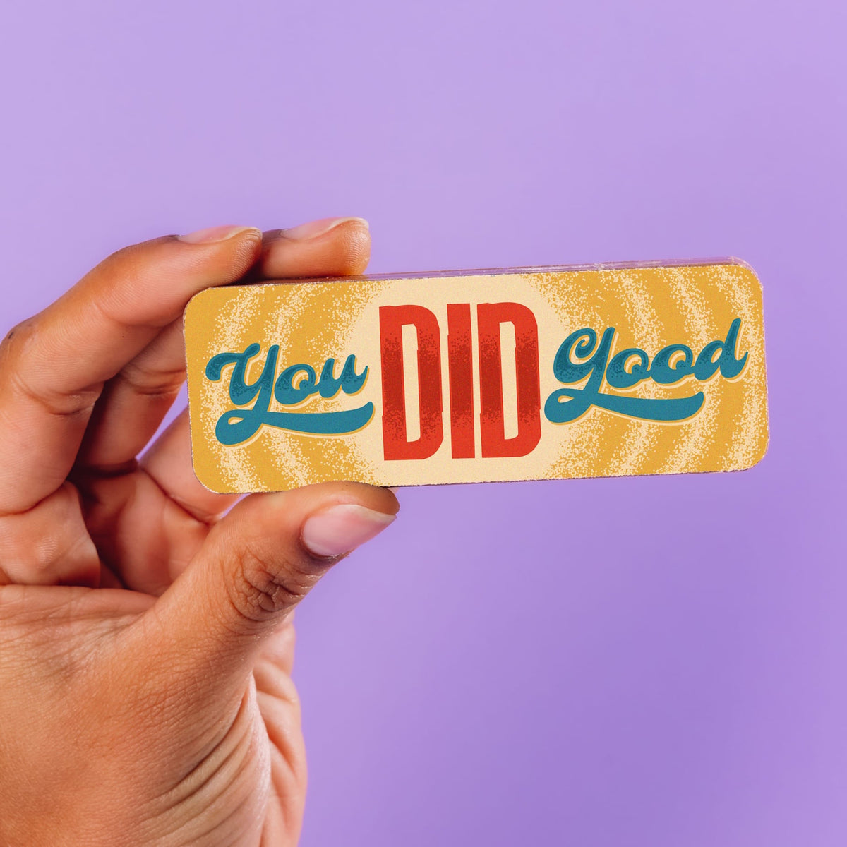 A hand holding up a colourfully decorated chocolate bar with a retro 'You did good' slogan.  Part of the Congratulations Chocolate Selection Box.