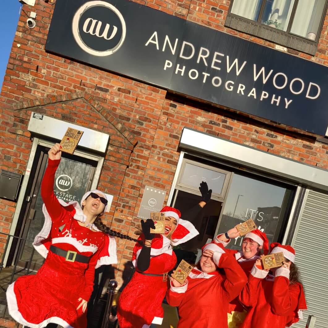 Andrew Wood Photography staff holding up chocolate medals provided for a Christmas event