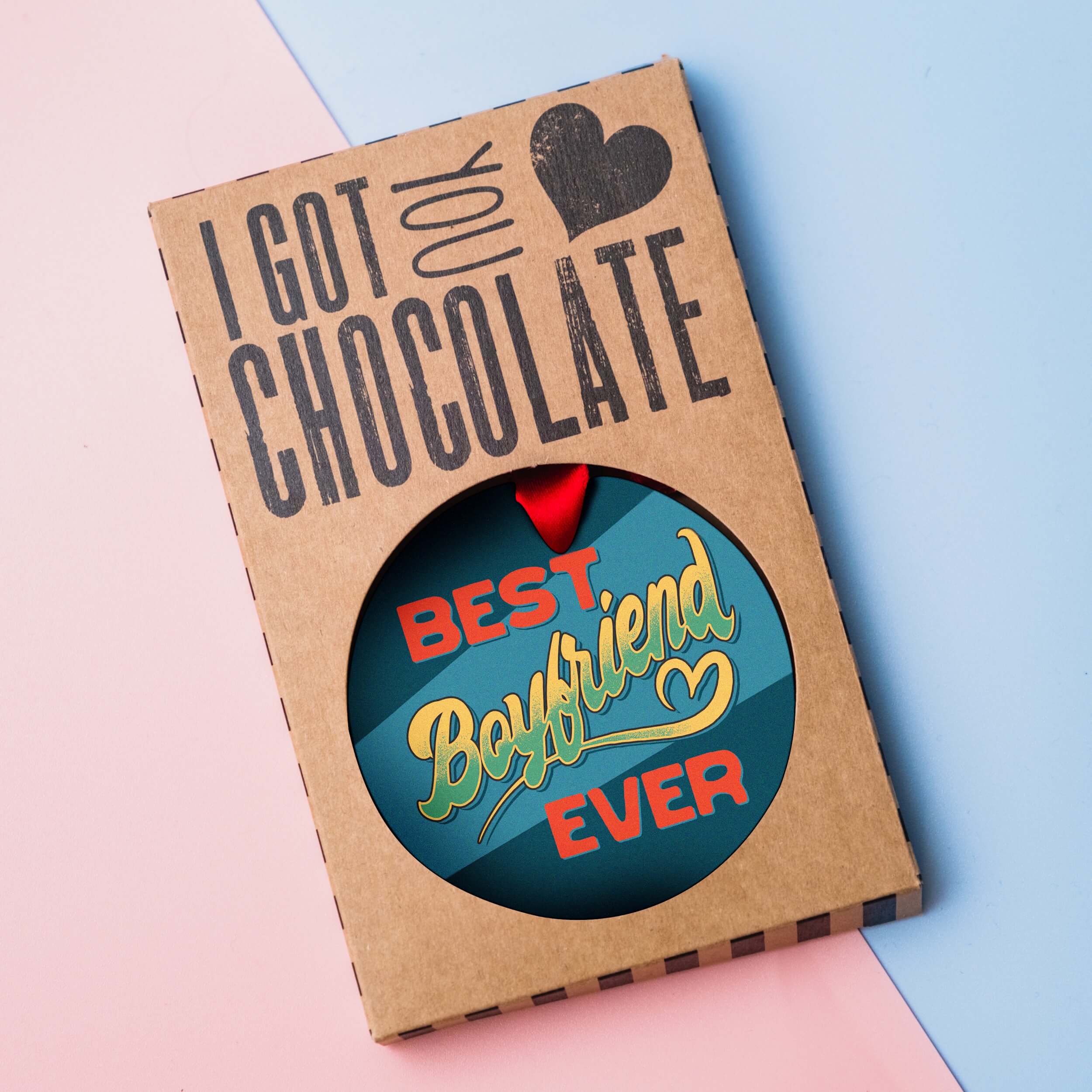 Best Boyfriend Ever milk chocolate medal presented in plastic-free “I got you chocolate” gift packaging on a pastel background.