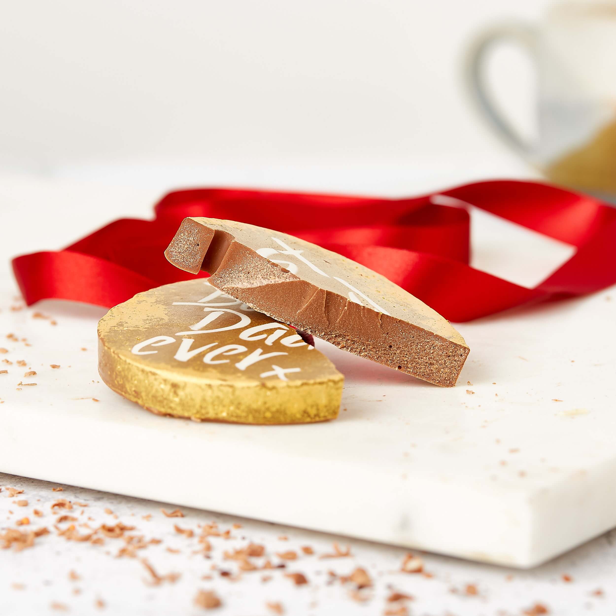 Thoughtful Father's Day Gifts - A broken chocolate medal with “Best Dad Ever” visible on the surface. 
 Thick, delicious, and way better than an actual gold one.