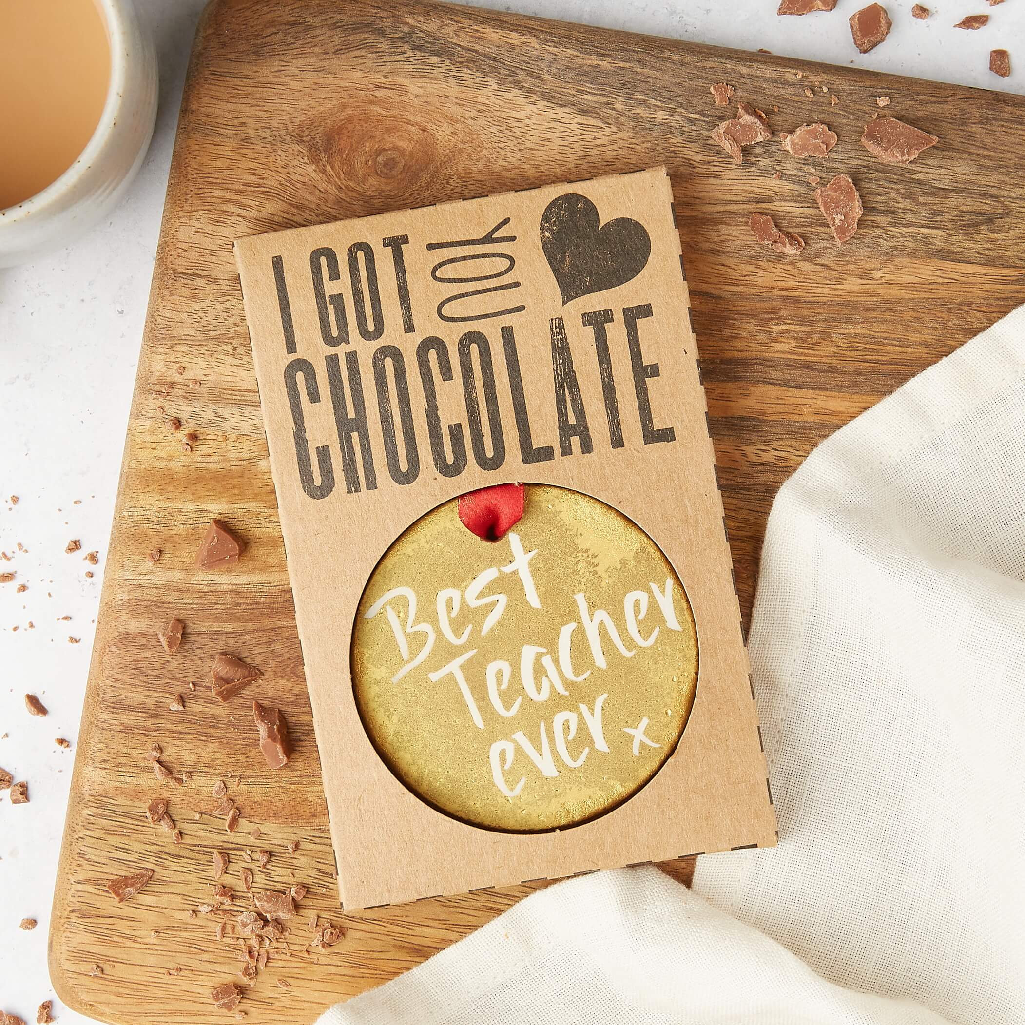 A gold chocolate medal that says “Best Teacher Ever” inside kraft “I got you chocolate” gift packaging.  Uniquely special small gifts for teachers.