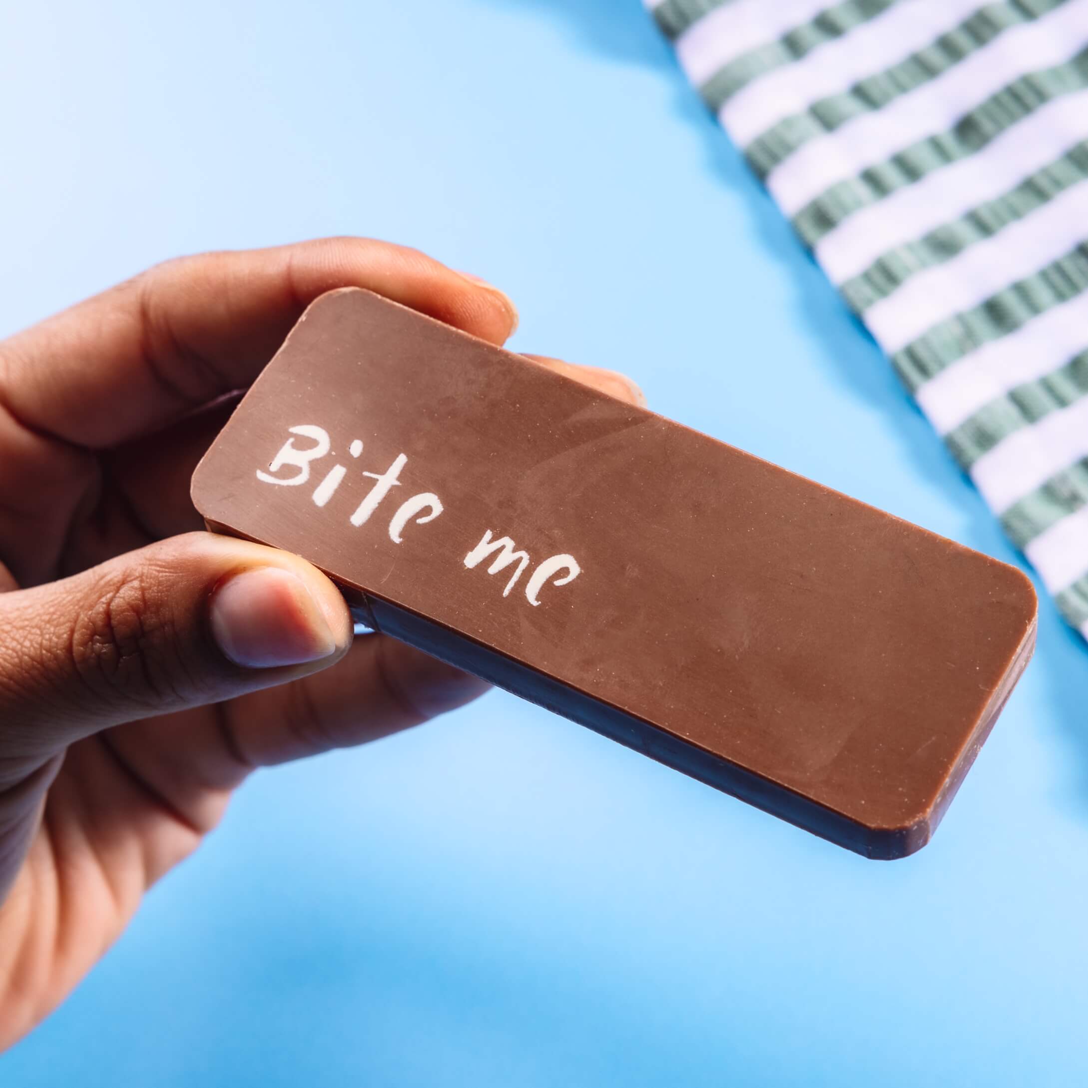 Solid Belgian milk chocolate bar with a 'Bite me' message