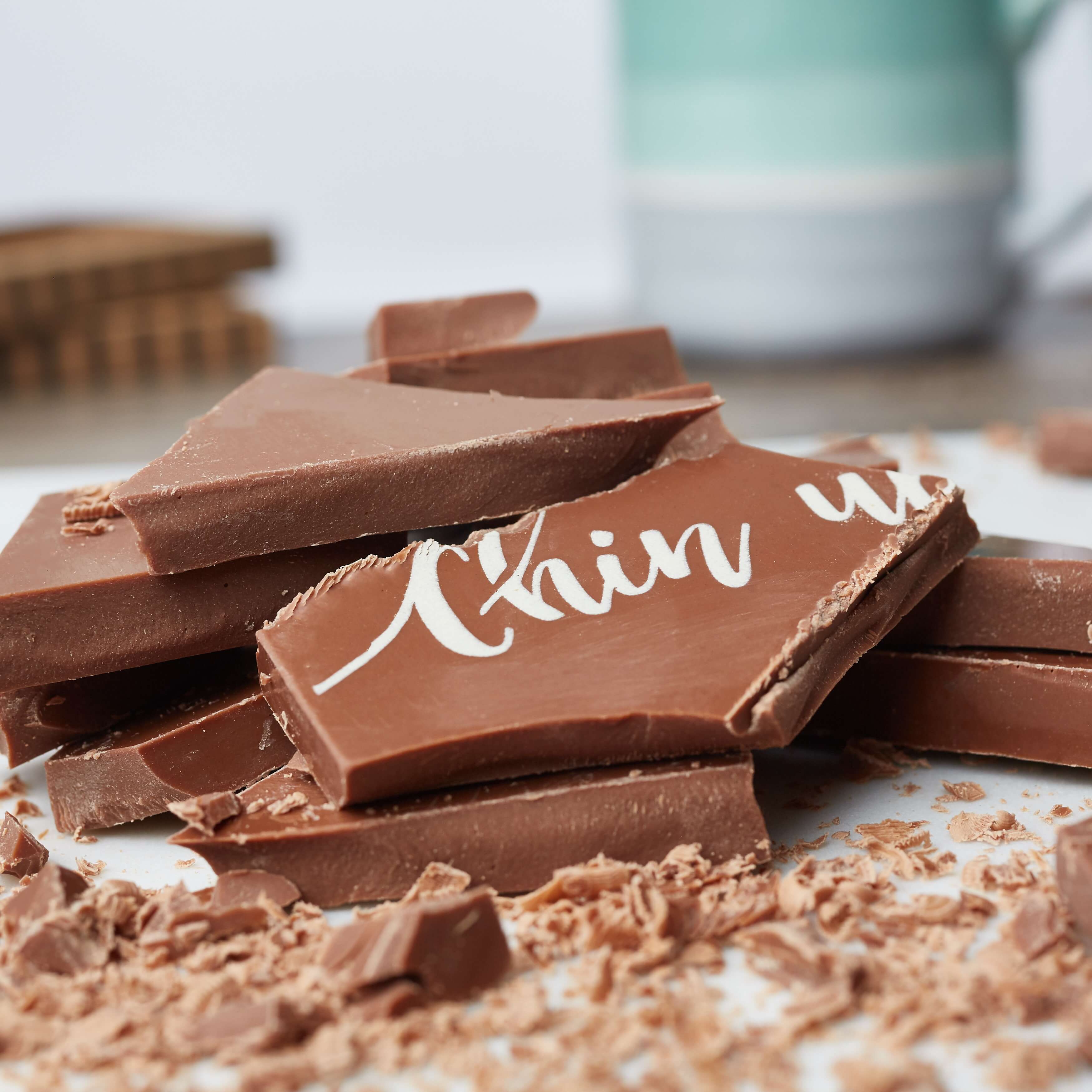Sending a Hug - Close-up of a broken 'Chin Up' treat showing chunky fairtrade Belgian milk chocolate body of the bar.
