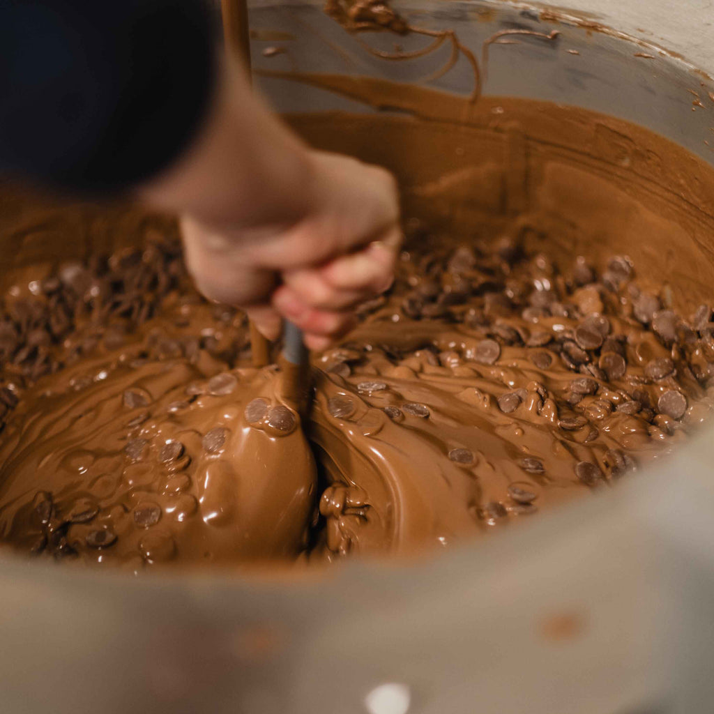 Chocolate chips being stirred whilst melting.