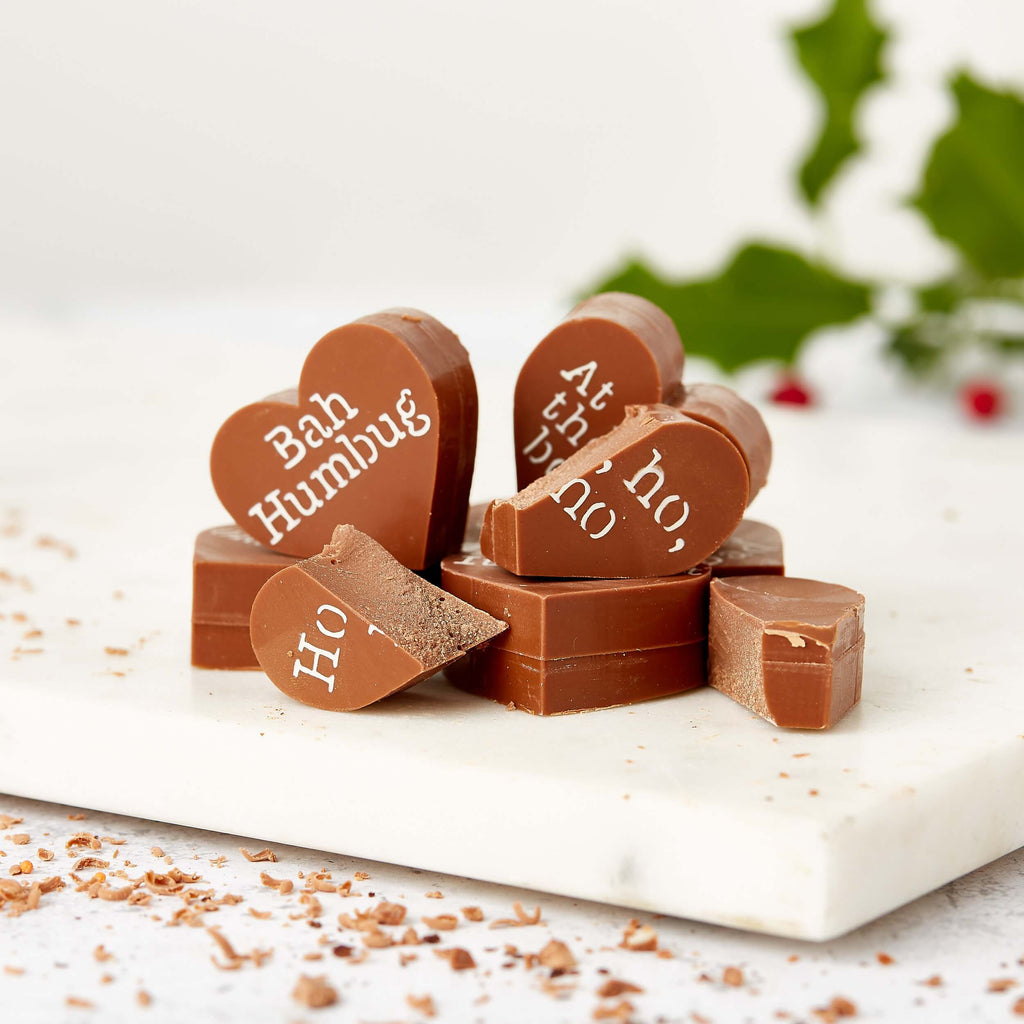 A pile of milk chocolate hearts decorated with grumpy festive phrases like “Ho, ho, no” and “Bah Humbug” – the ultimate funny Christmas chocolate for the merrily miserable.