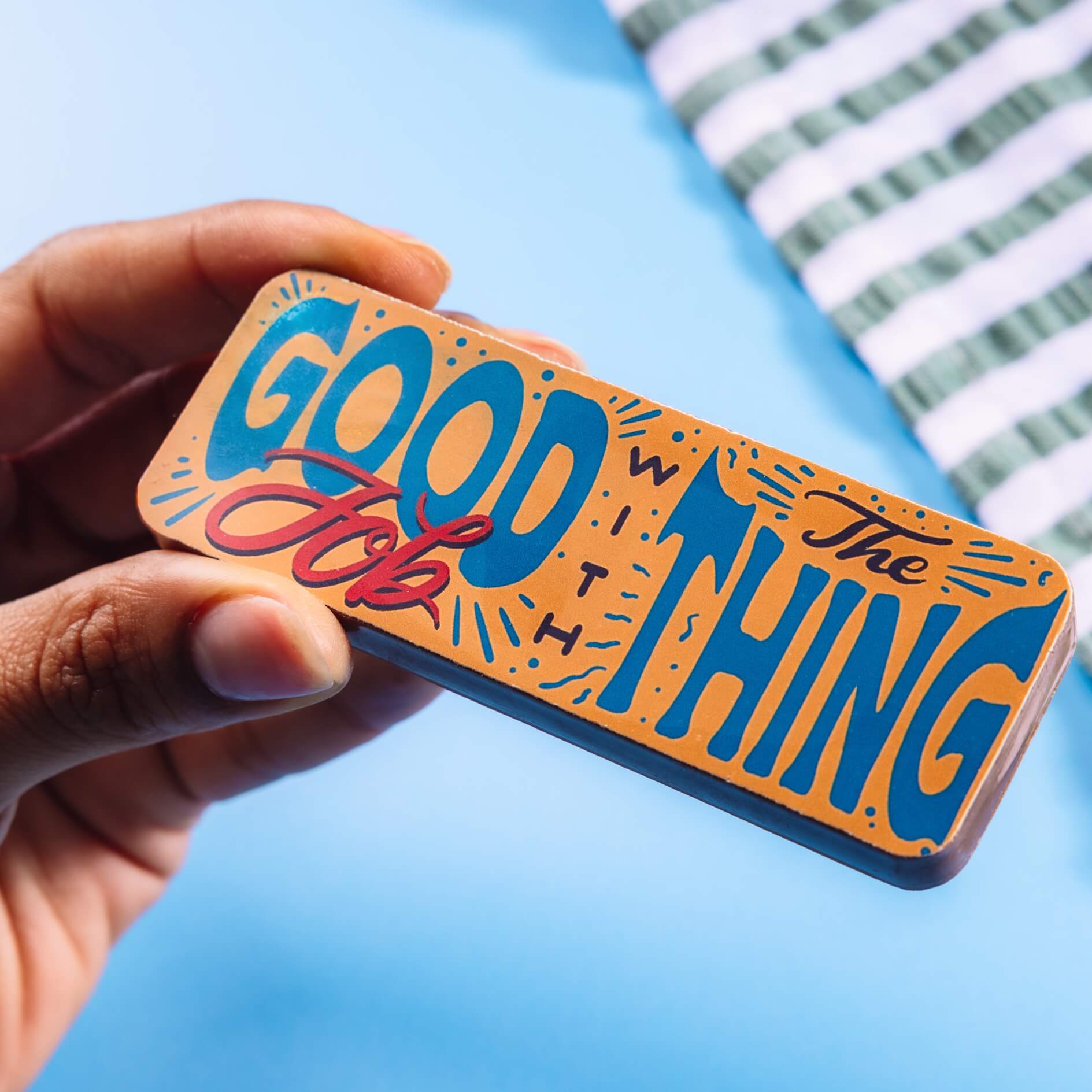 Close-up of a chocolate bar with colourful typography that reads “Good job with the thing” – brilliant as exam congratulations gifts and made with top quality Fairtrade Belgian chocolate.