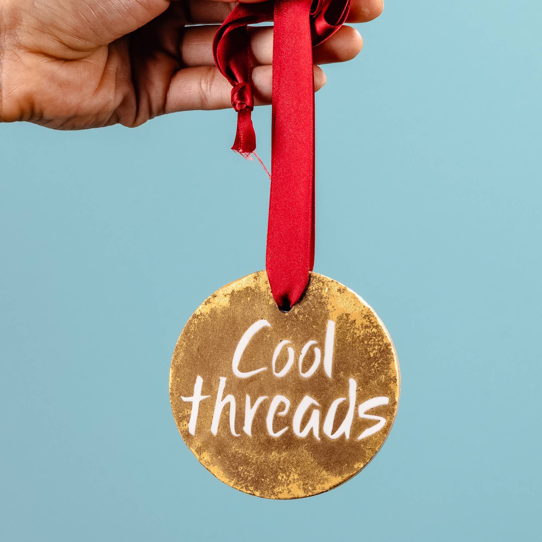 An example of a custom chocolate gold medal we made for an event... a prize in the sixties themed costume competition reading 'Cool Threads'