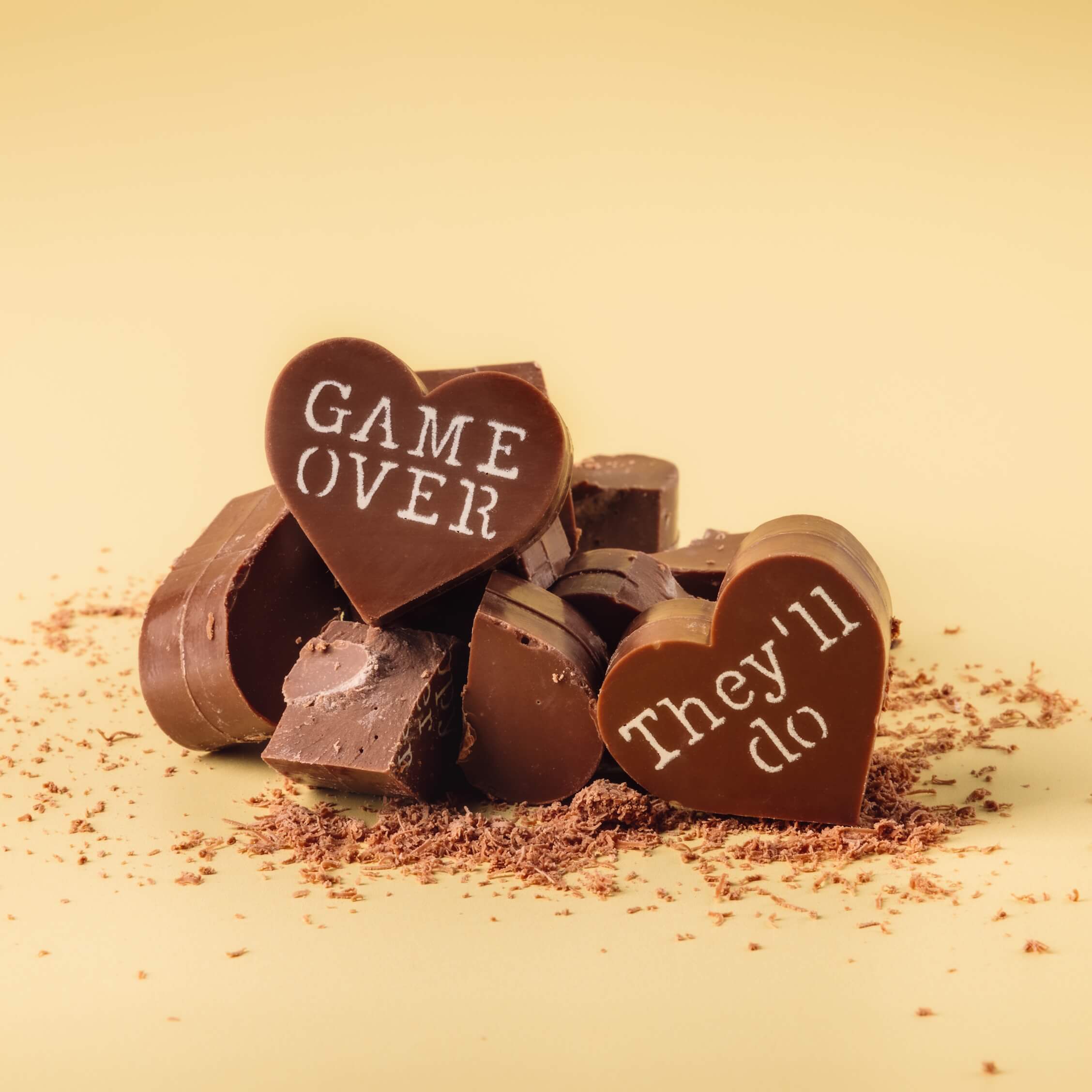 Engagement Gift Ideas - Close-up of broken Bagstock & Bumble Obnoxious Chocs hearts showing the chunky, premium Fairtrade Belgian chocolate centres.