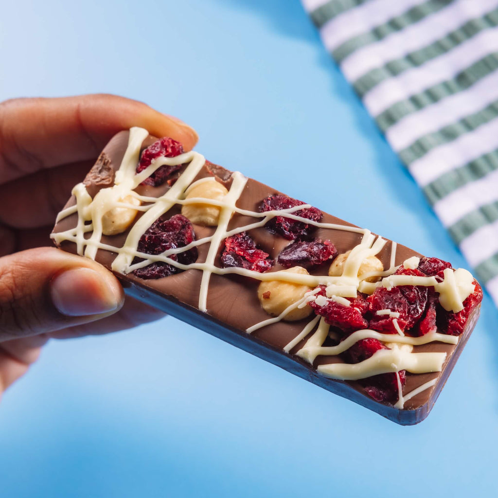 Chunky Belgian milk chocolate bar packed with hazelnuts and dried cranberries and drizzled with white chocolate