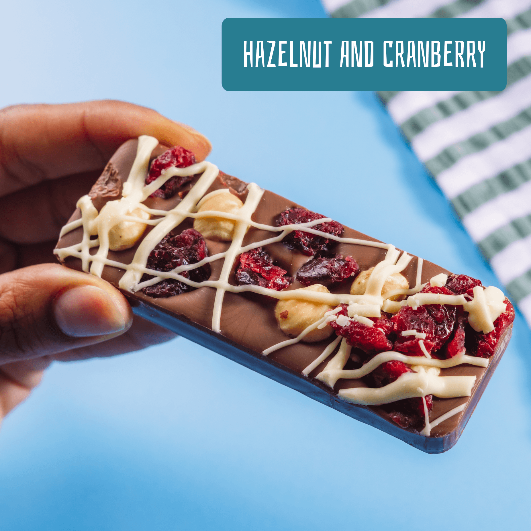 Chunky Belgian milk chocolate bar packed with hazelnuts and dried cranberries and drizzled with white chocolate