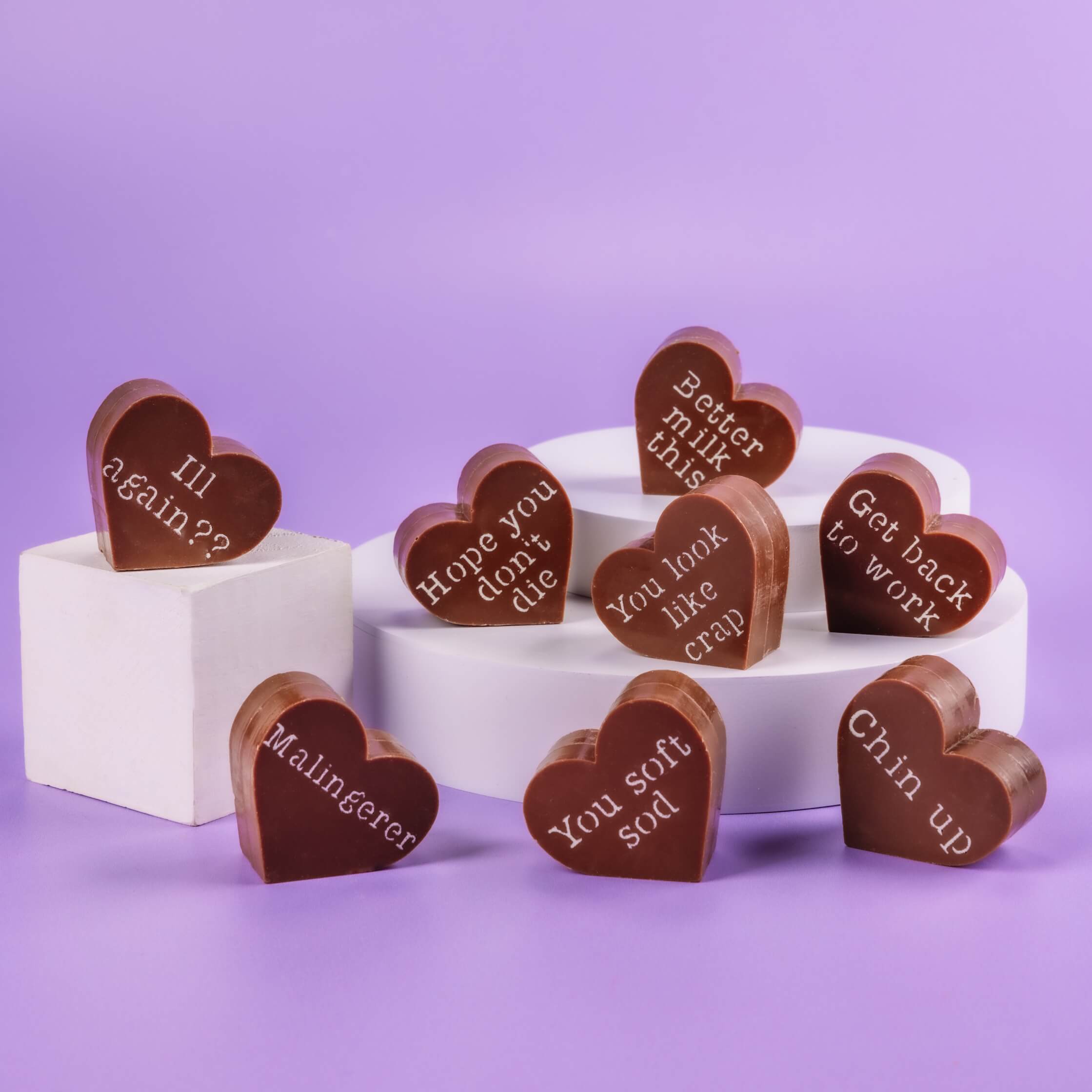 Bagstock & Bumble Get Well Soon chocolate hearts on plinths, showing slogans like 'You soft sod' and 'You look like crap'.