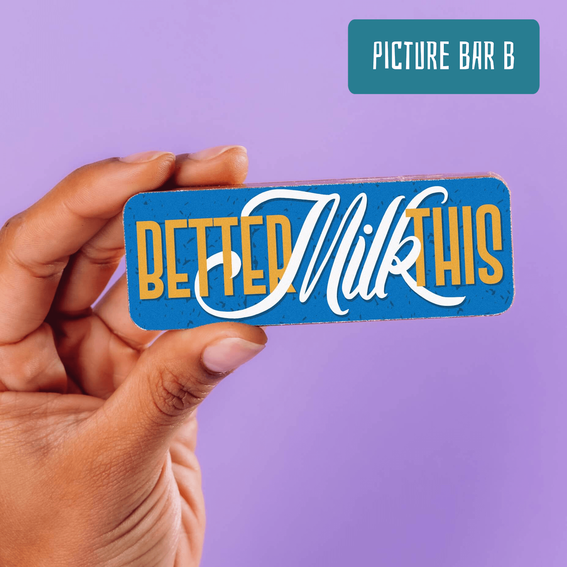 A hand holding a cheeky Bagstock & Bumble chocolate bar with the phrase "Better Milk This" in bold lettering against a blue background. A perfect pick for anyone recovering and in need of a good laugh.