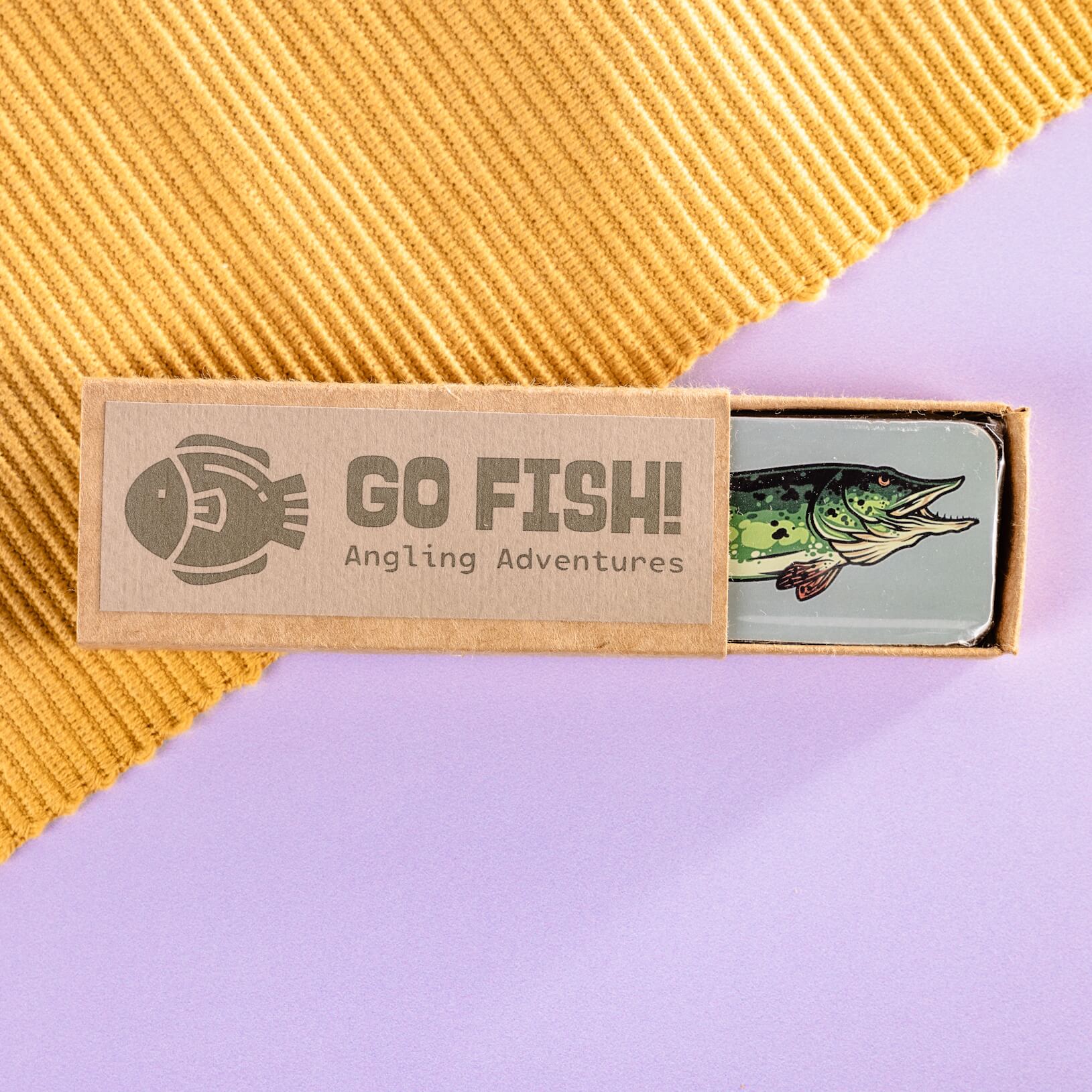 And example corporate chocolate with an illustration of a fish on the chocolate itself and a branded 'Go Fish! Angling Adventures' box