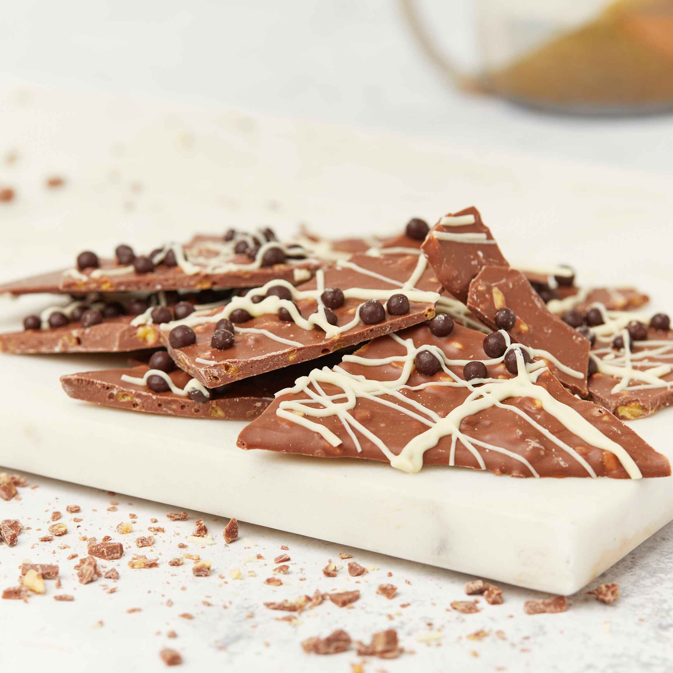 A pile of scrummy chocolate shards with honeycomb pieces, chocolate crispearls, and white choc drizzle – a perfect chocoholic gift with serious appeal.