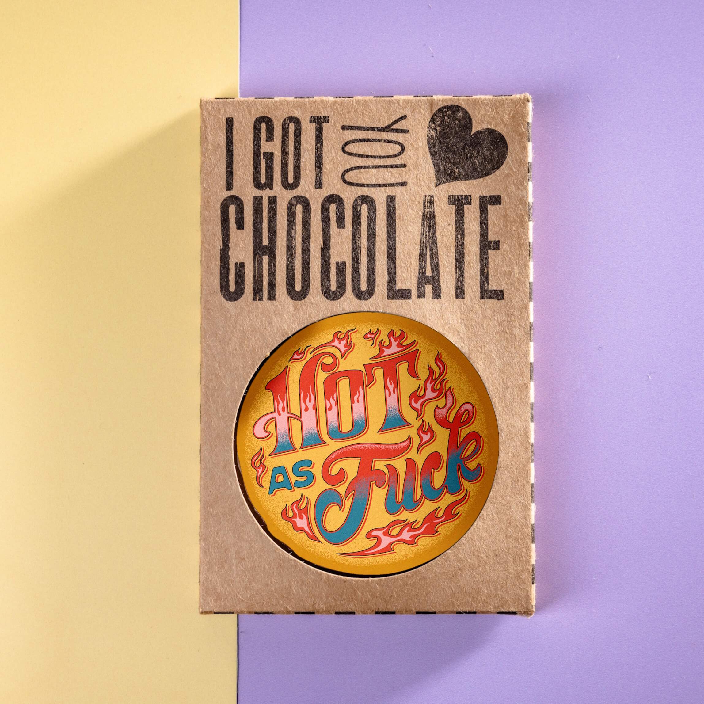 Milk chocolate disc with “Hot As Fuck” edible transfer, presented in plastic-free “I got you chocolate” gift packaging on a pastel background.