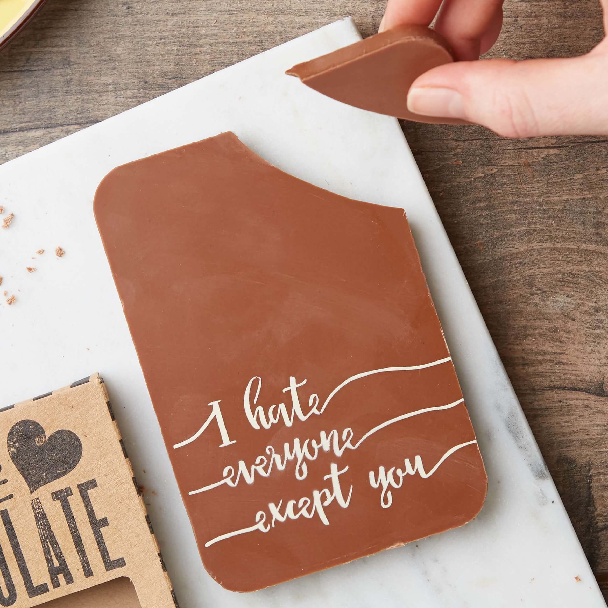 A milk chocolate bar with ‘I hate everyone except you’ message, with the corner broken off.  A Valentine's gift funny chocolate bar to make someone smile.
