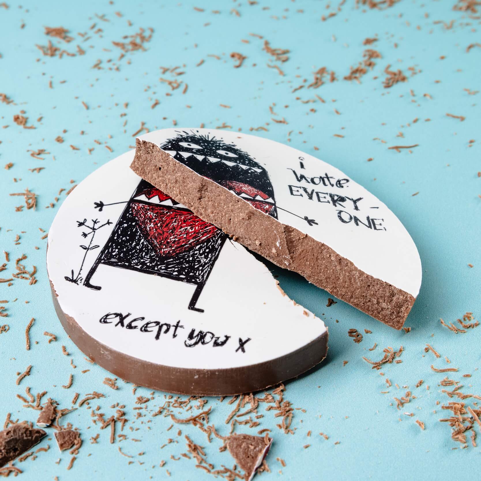 Funny milk chocolate disc broken in two, showing the inside while still clearly displaying the monster and “I hate everyone except you” message – ideal best friend gift for the person you tolerate most.