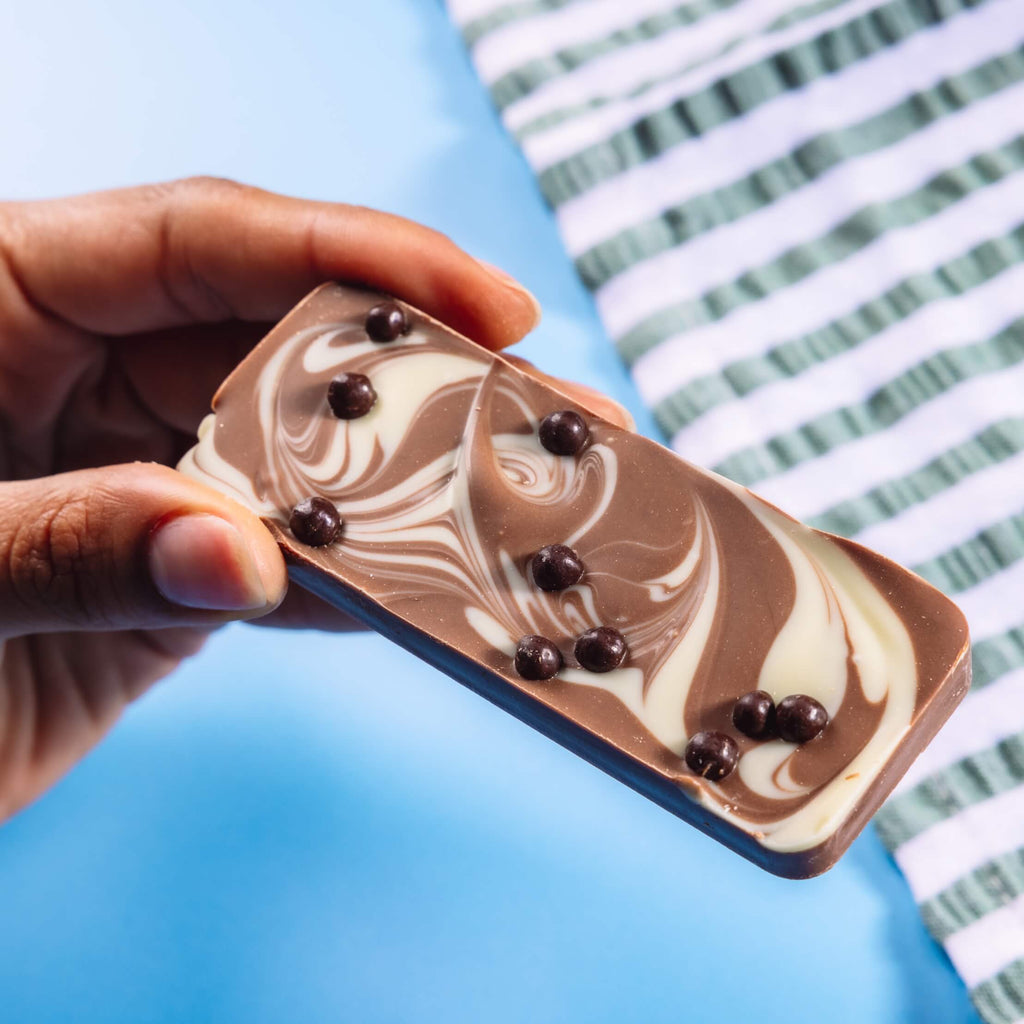 Fairtrade marbled milk and white chocolate bar topped with crispy dark chocolate balls