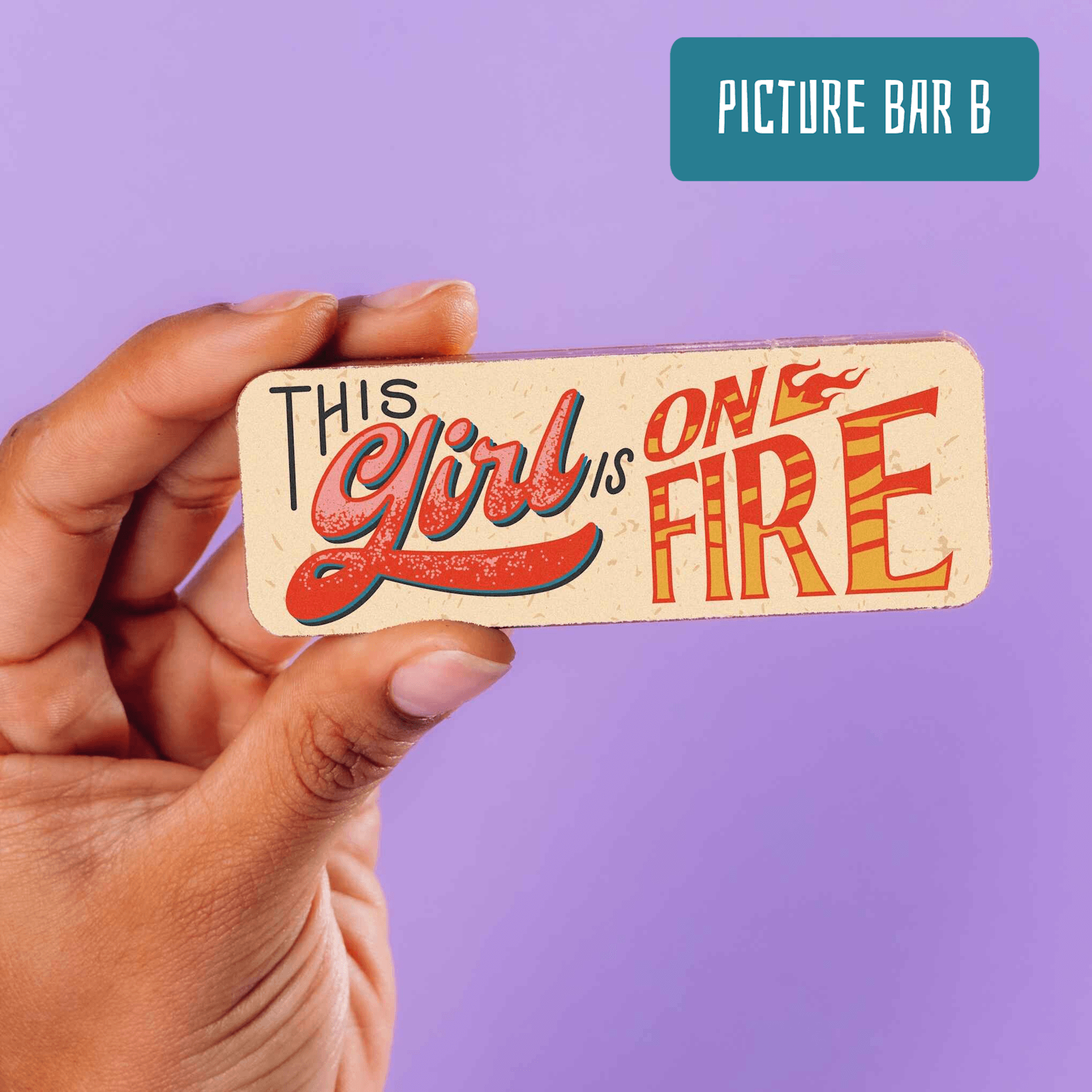 A close-up of a chocolate bar that reads “This Girl is On Fire” in bold, retro-style lettering. Both a compliment and a comment on the hot flush situation.