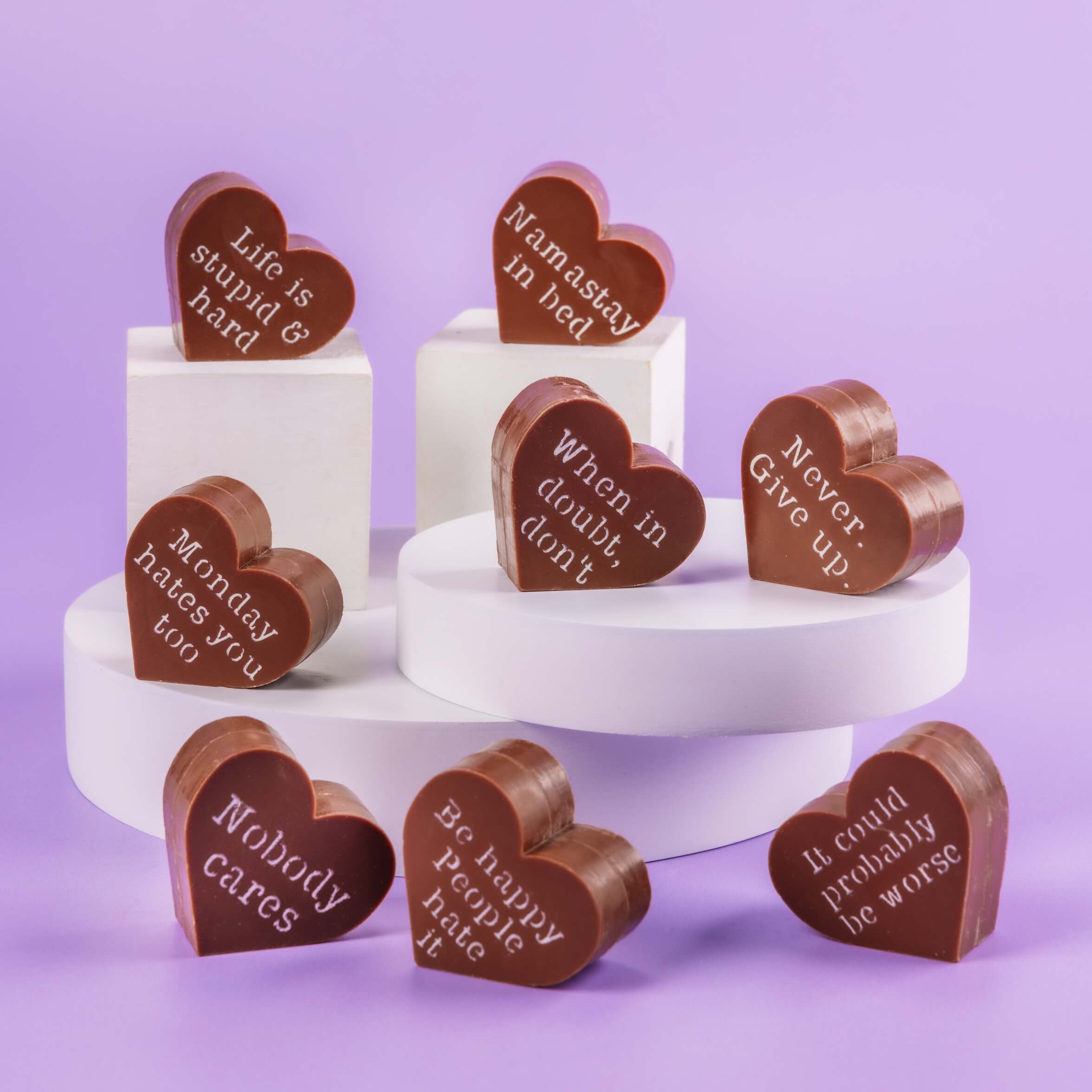 Bagstock & Bumble Inspirational chocolates on plinths, showing slogans like 'Namastay in bed' and 'When in doubt, don’t' – perfect novelty chocolates for friends.