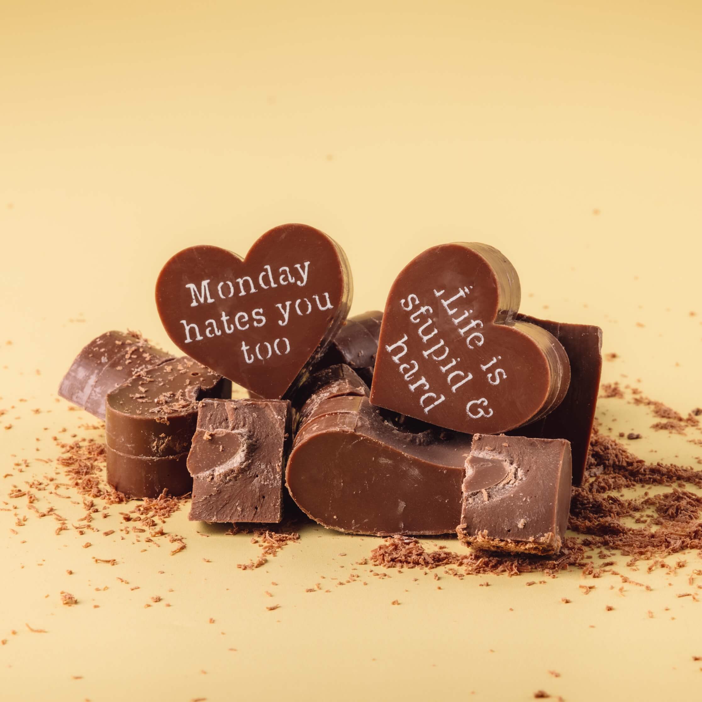 Cheeky Presents for Her - Broken pieces from Bagstock & Bumble Obnoxious Chocs, showing the scrumptious thick Belgian chocolate hearts with funny messages.