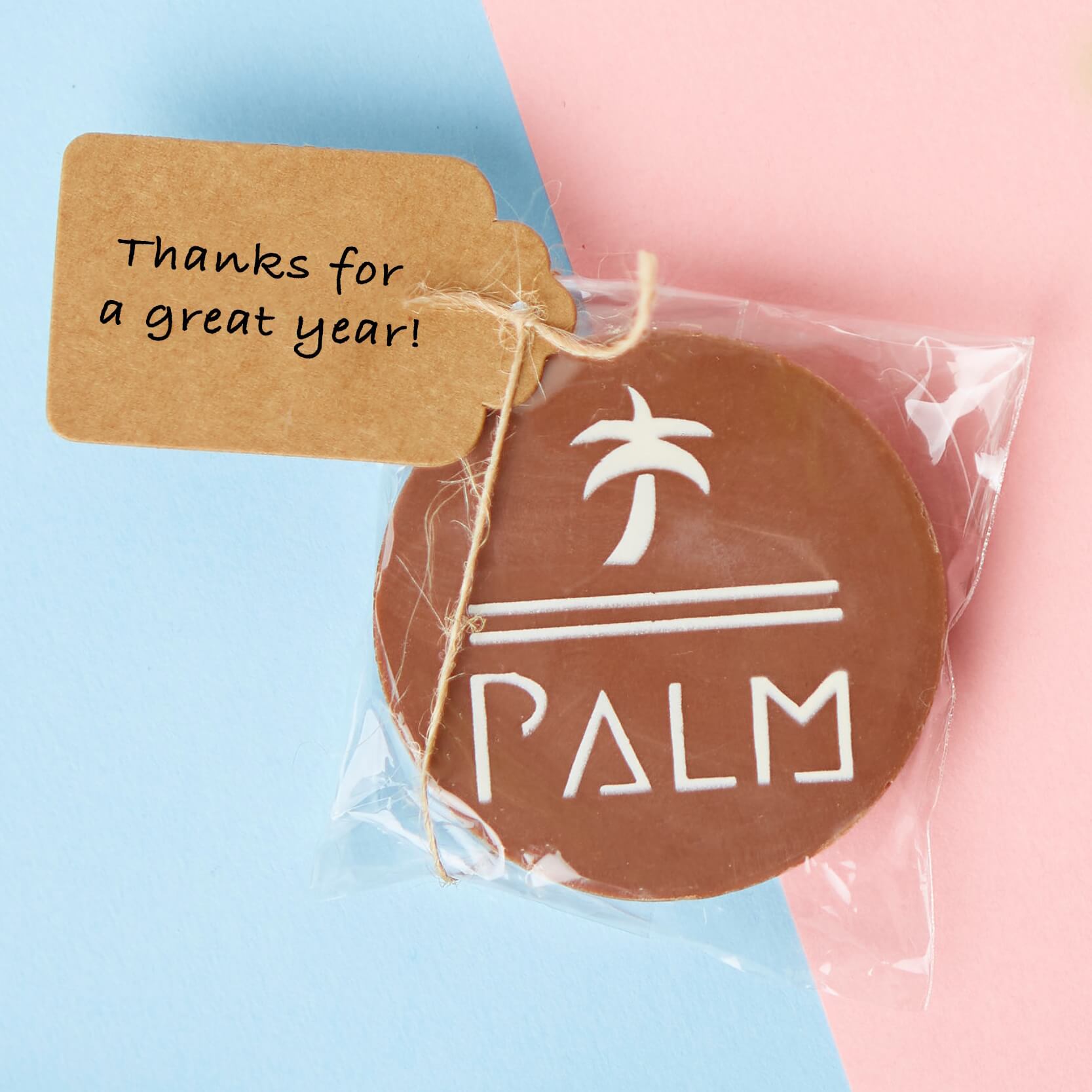 Corporate milk chocolate disc with a PALM logo, packaged as a gift with a 'thanks for a great year' message on the tag