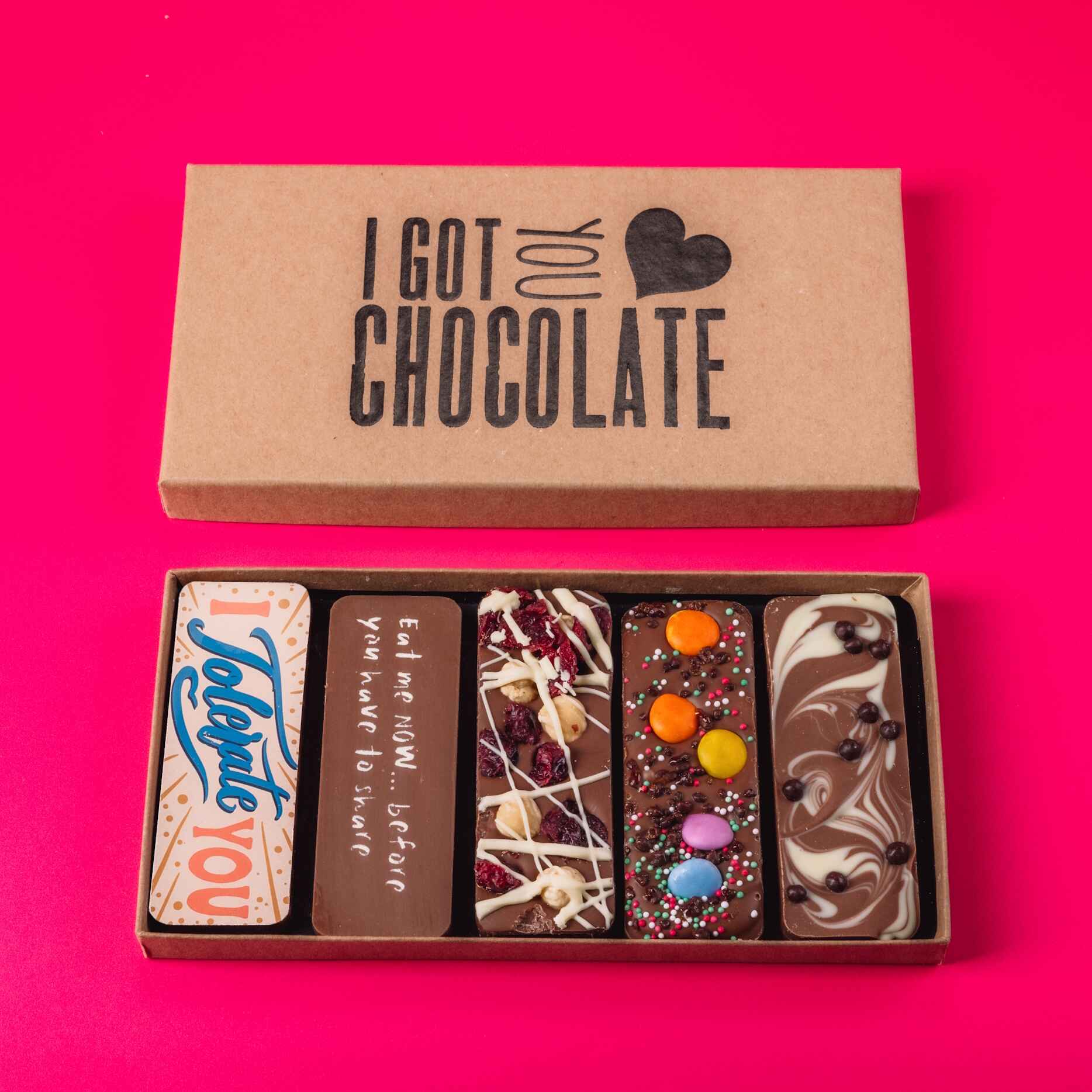 A full set of five quirky chocolate bars in a kraft “I got you chocolate” box, including one that says “I Tolerate You” – a cheeky Valentine's chocolate gift that skips the clichés.