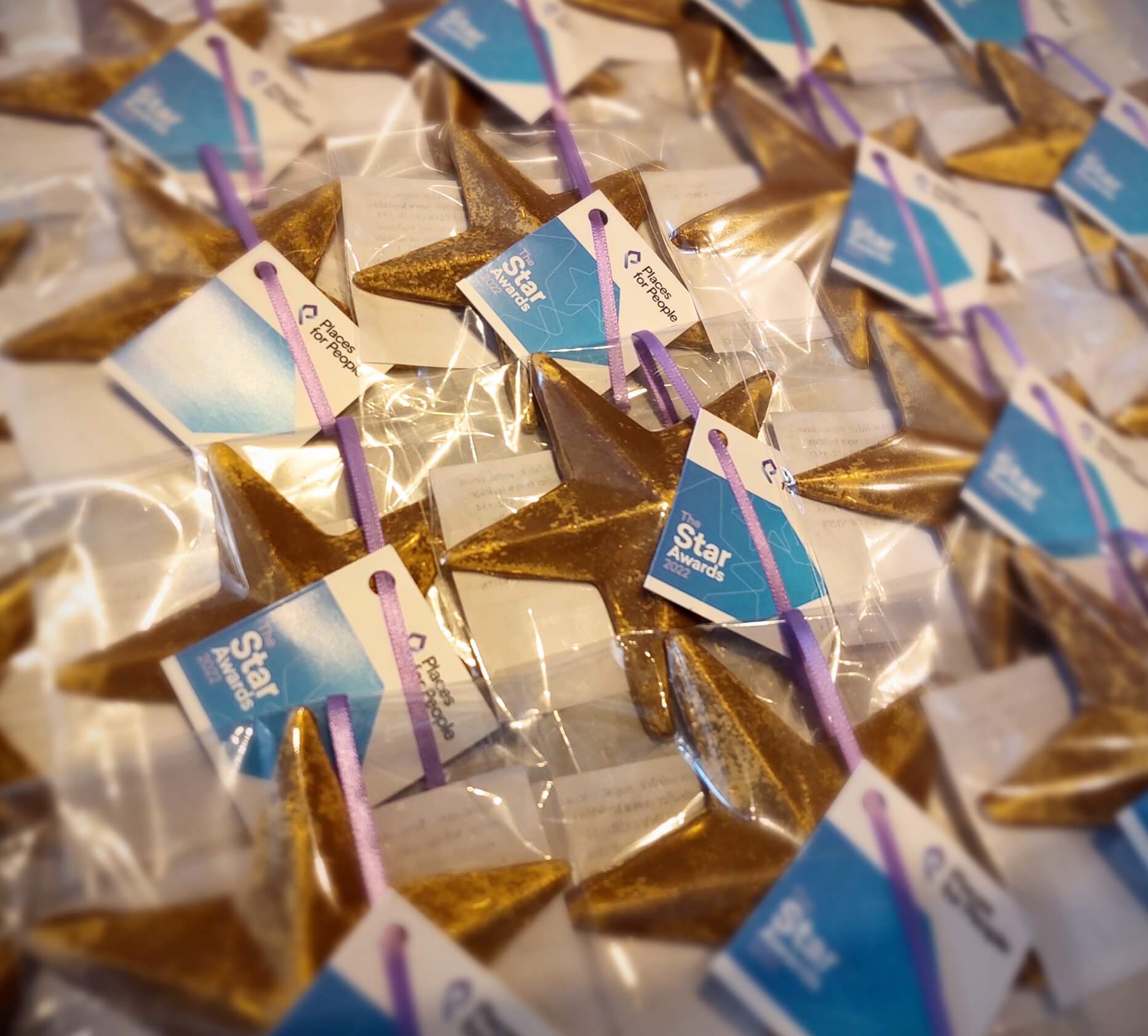 A selection of milk chocolate gold stars made for a corporate event on behalf of People for Places