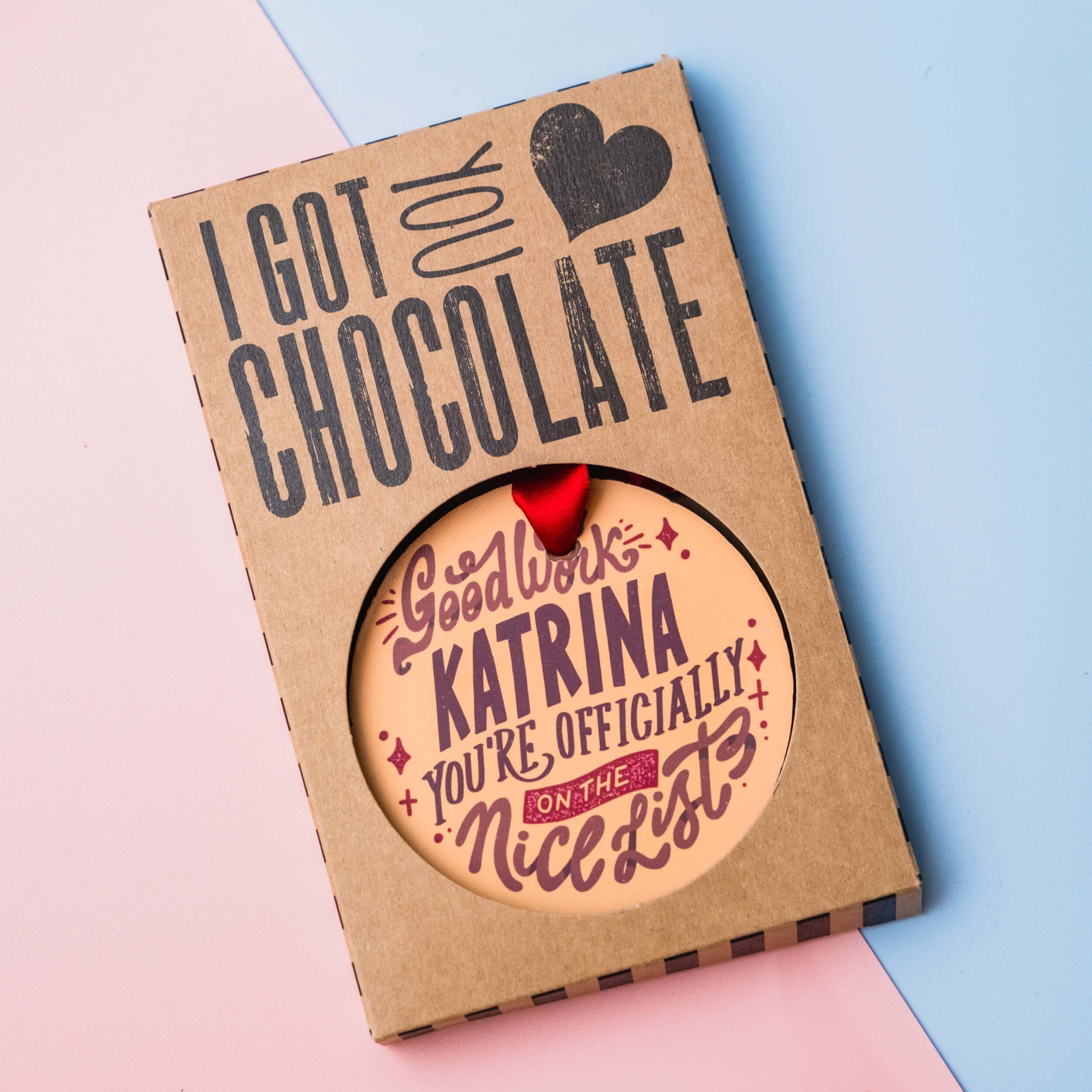 Personalised Christmas chocolate medal shown in custom gift packaging
