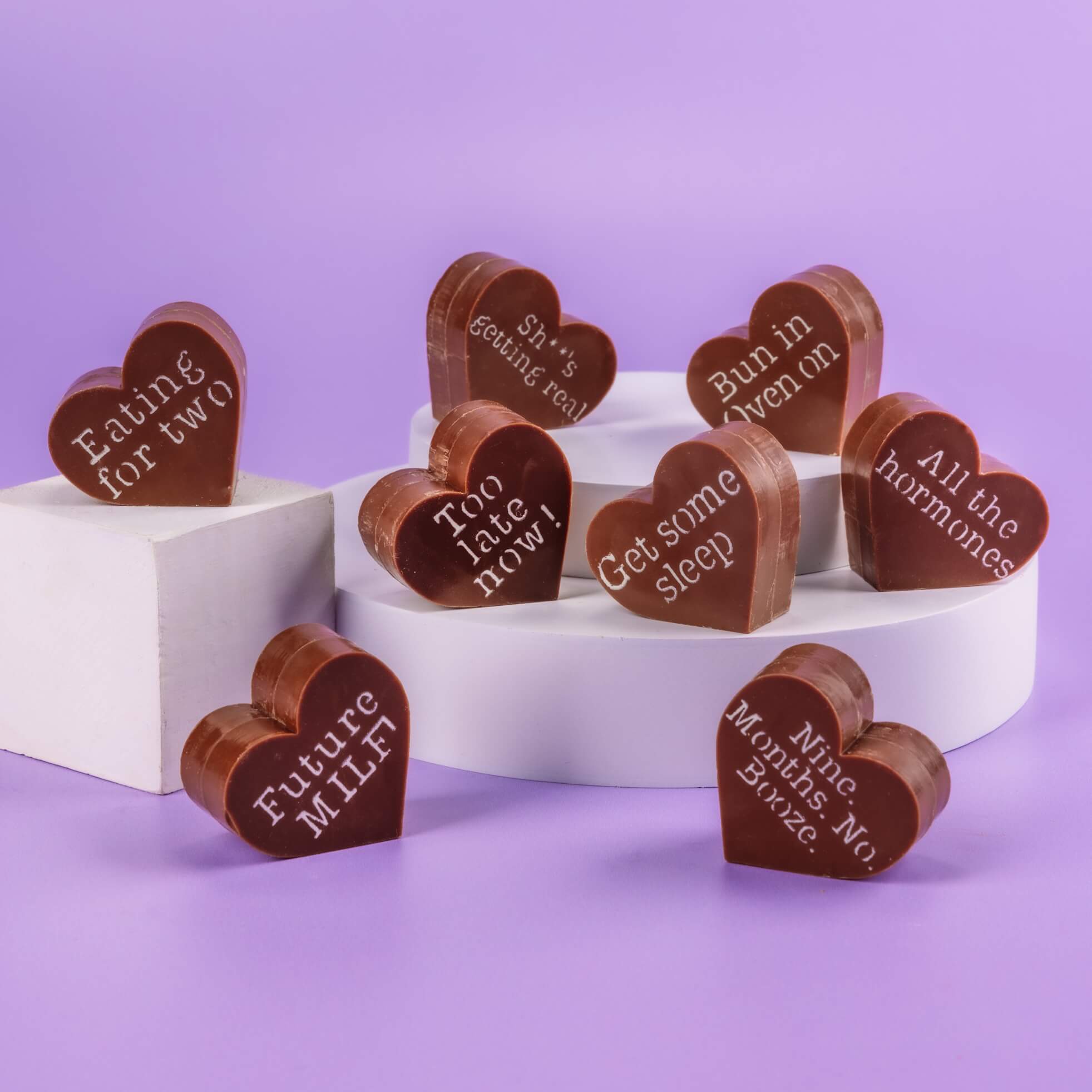 Present for Pregnant Friend - Assortment of Bagstock & Bumble heart-shaped Fairtrade Belgian chocolates, each with witty pregnancy phrases like 'Too late now!' and 'Sh*t’s getting real'.