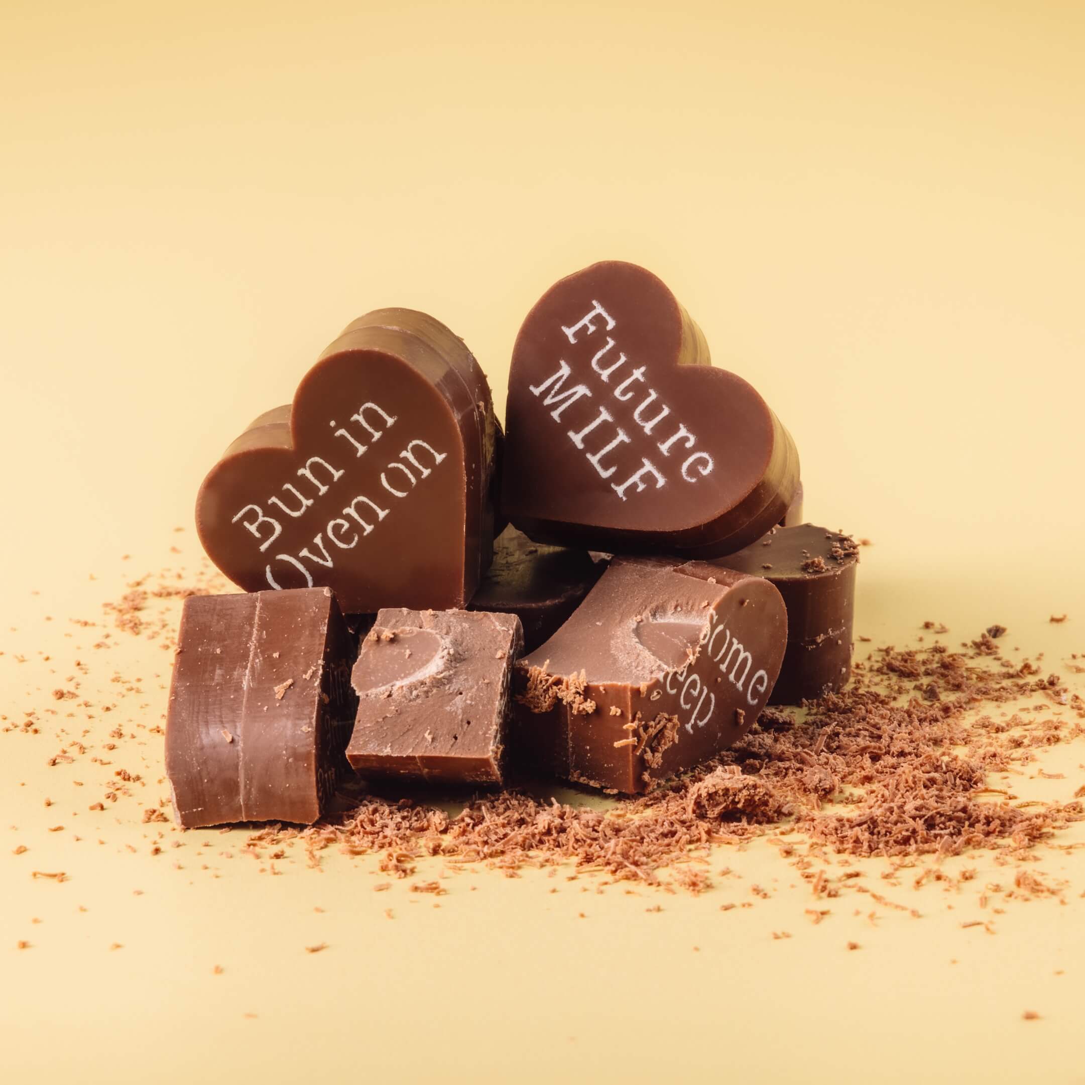 Gifts for Baby Showers - Detailed view of broken Bagstock & Bumble pregnancy chocolates, highlighting the rich, chunky Fairtrade Belgian chocolate made for seriously satisfying indulgence.