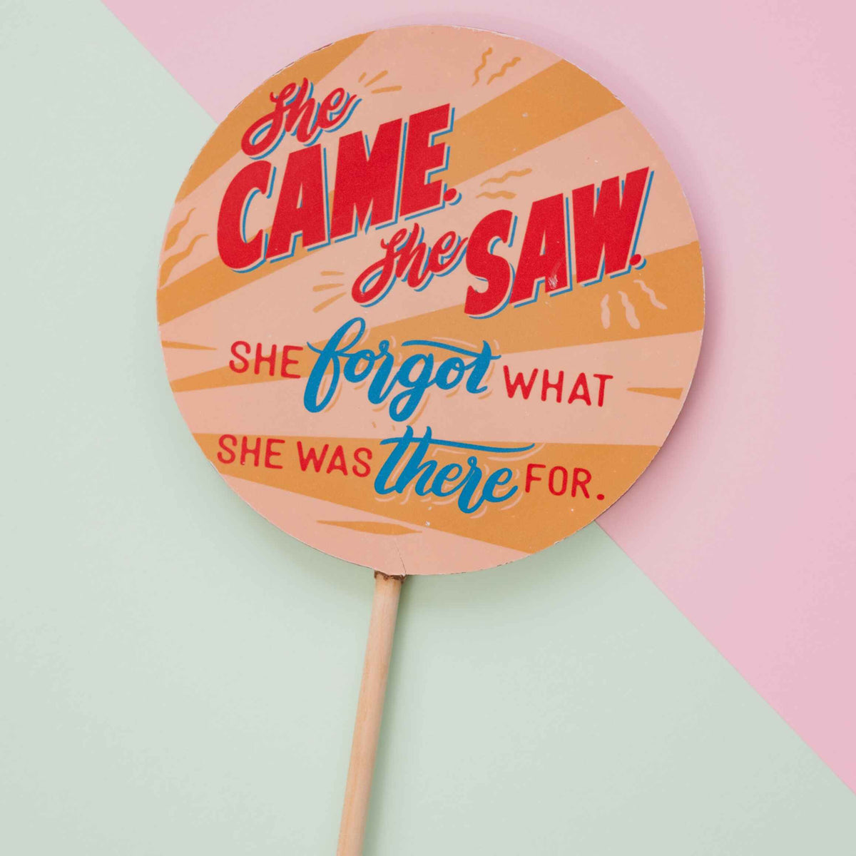 A close up shot of the funny perimenopause chocolate lolly with a cheeky ‘She came, she saw, she forgot what she was there for’