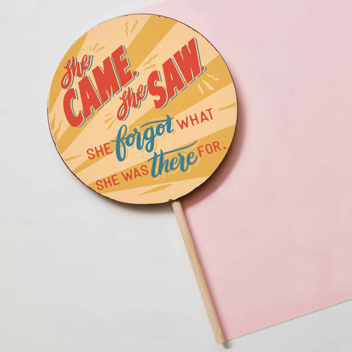 A flat lay view of the full ‘She came, she saw…’ chocolate lolly gift for ladies – showing the giant chocolate body of the lolly and the wooden stick