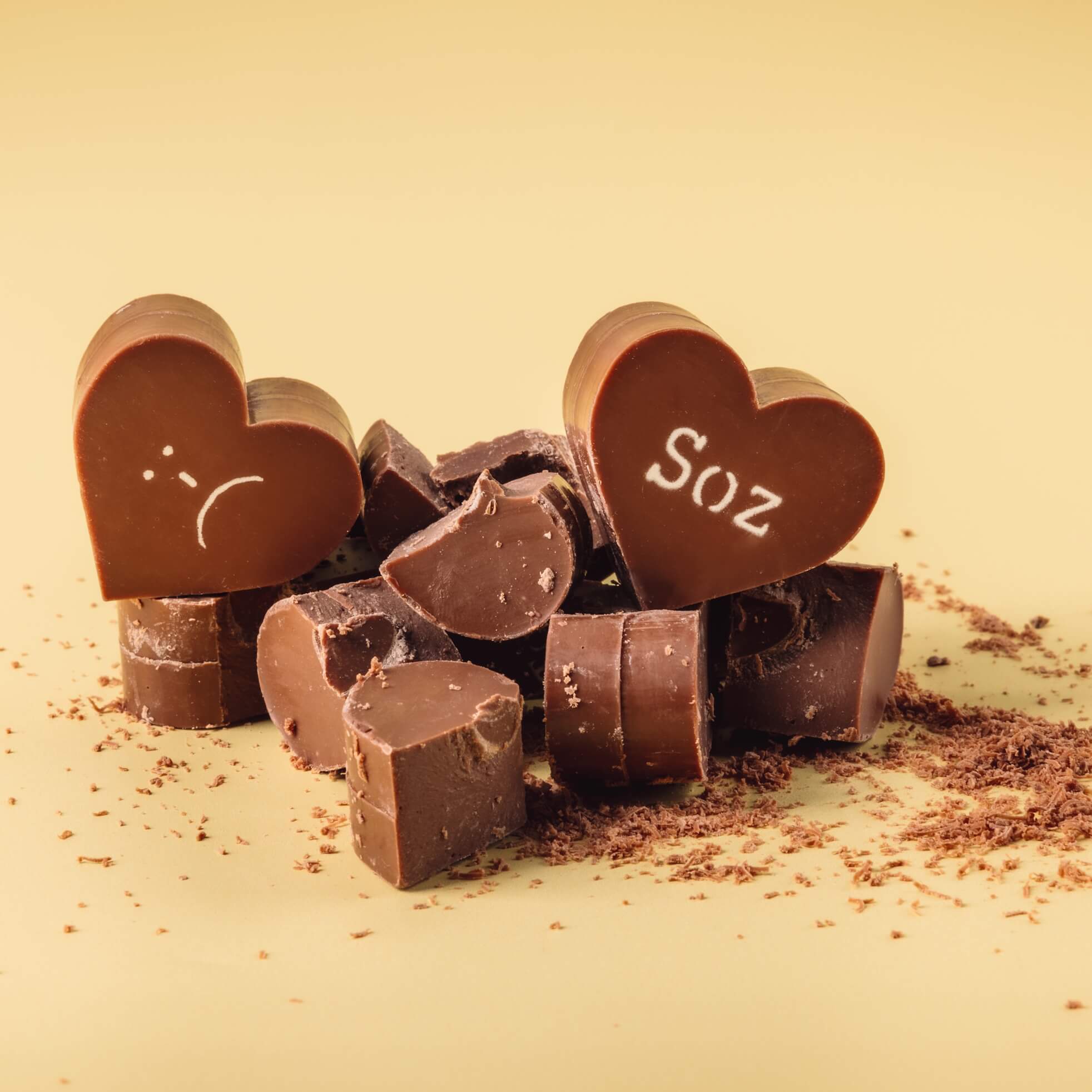 Sorry Chocolate Gift - Broken chocolate hearts from Bagstock & Bumble Sorry Obnoxious Chocs set, showing thick Belgian chocolate with cocoa butter slogans.