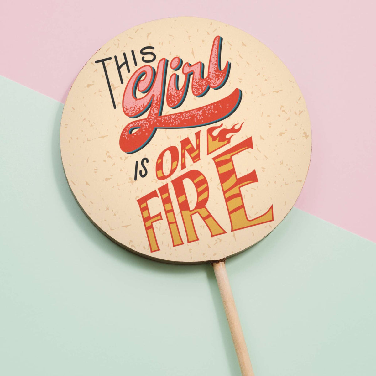Our jumbo milk chocolate ‘This girl is on fire’ lolly shown on a pastel background… for girls who are killing it, and ones who are quite literally burning up from hot flushes!