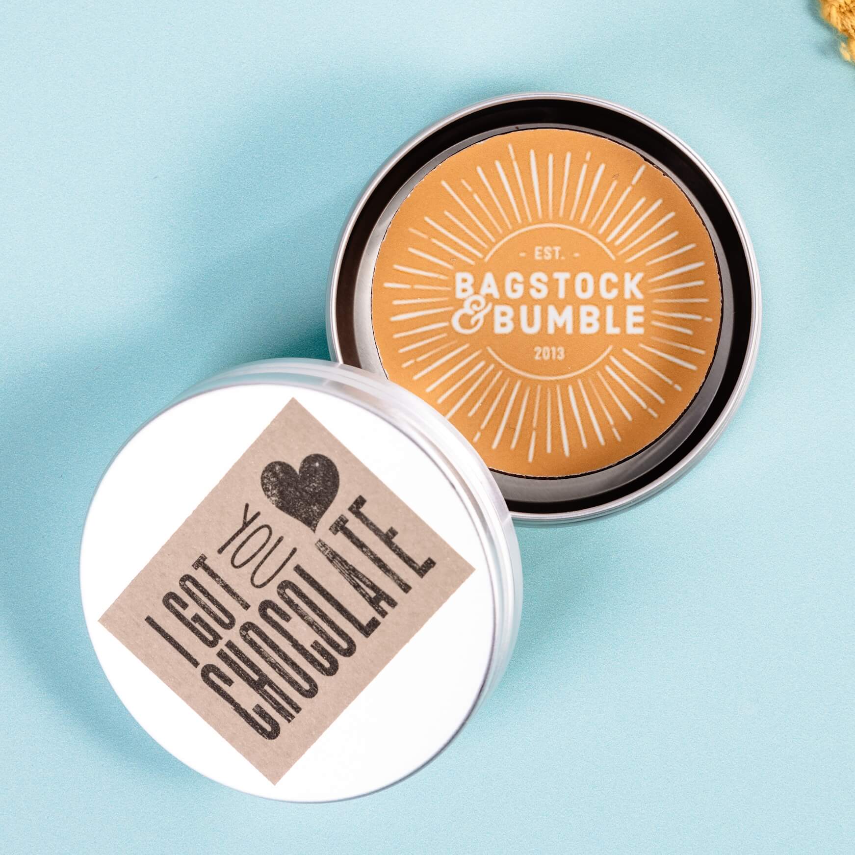 An example of a corporate chocolate disc using Bagstock & Bumble's logo on the chocolate and presented in an individual branded metal tin