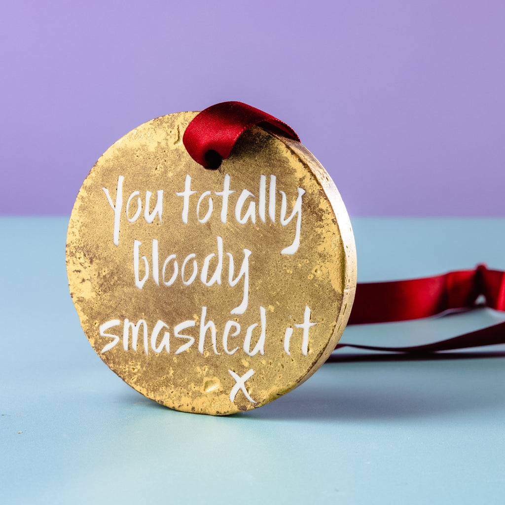 Chocolate Gold Medal stood up on it's side to show off the gold lustre and 'You totally bloody smashed it' message