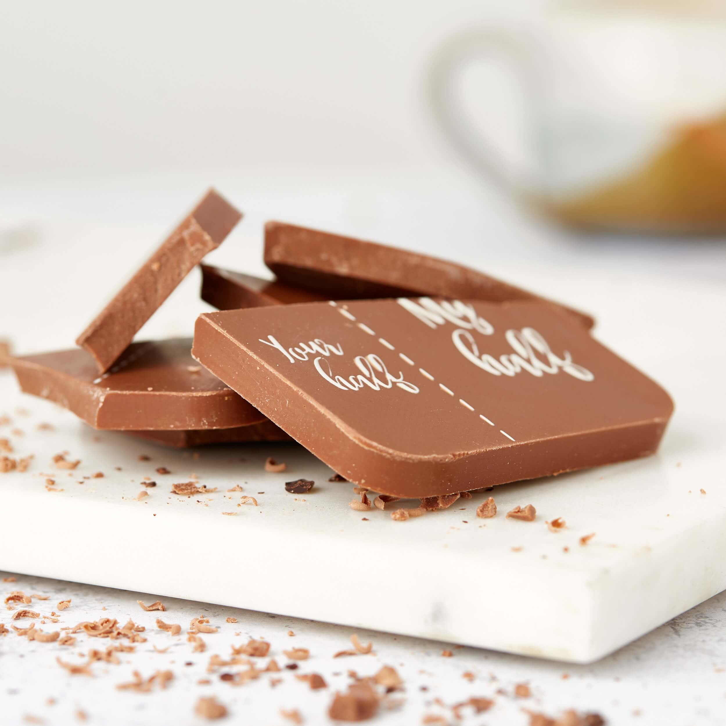 Chocolate Gifts UK - Stacked pieces of a broken milk chocolate bar showing the unequal “Your half / My half” message.  Sweet, petty, and perfectly fair-trade.