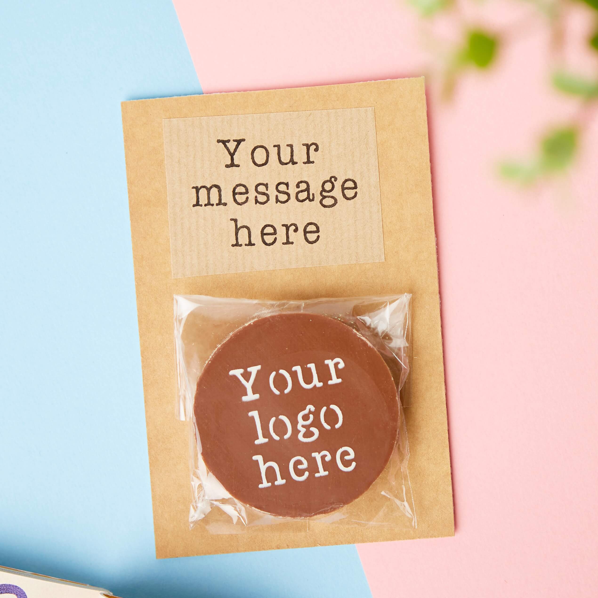 A sample corporate chocolate packaging idea - a circular chocolate on a backing board with spaces to add 'Your message here'