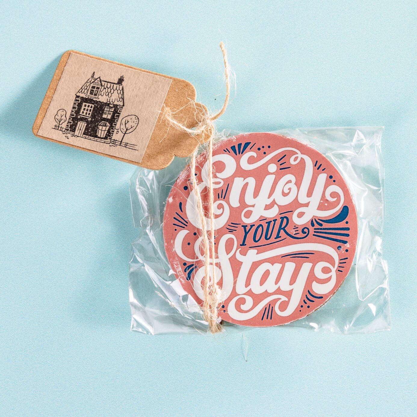 Bespoke 'Enjoy your stay' chocolate disc, packaged with a custom tag