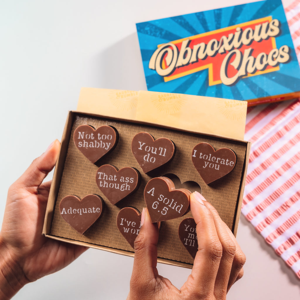 Box of funny Valentine’s chocolates with cheeky messages - perfect for a gift that says ‘romance is overrated, but chocolate isn’t.