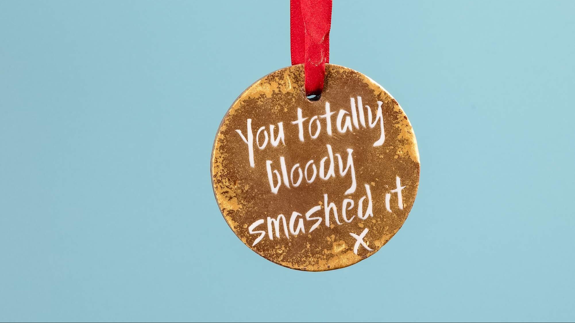 A chocolate gold medal for a marathon runner reading 'You totally bloody smashed it'