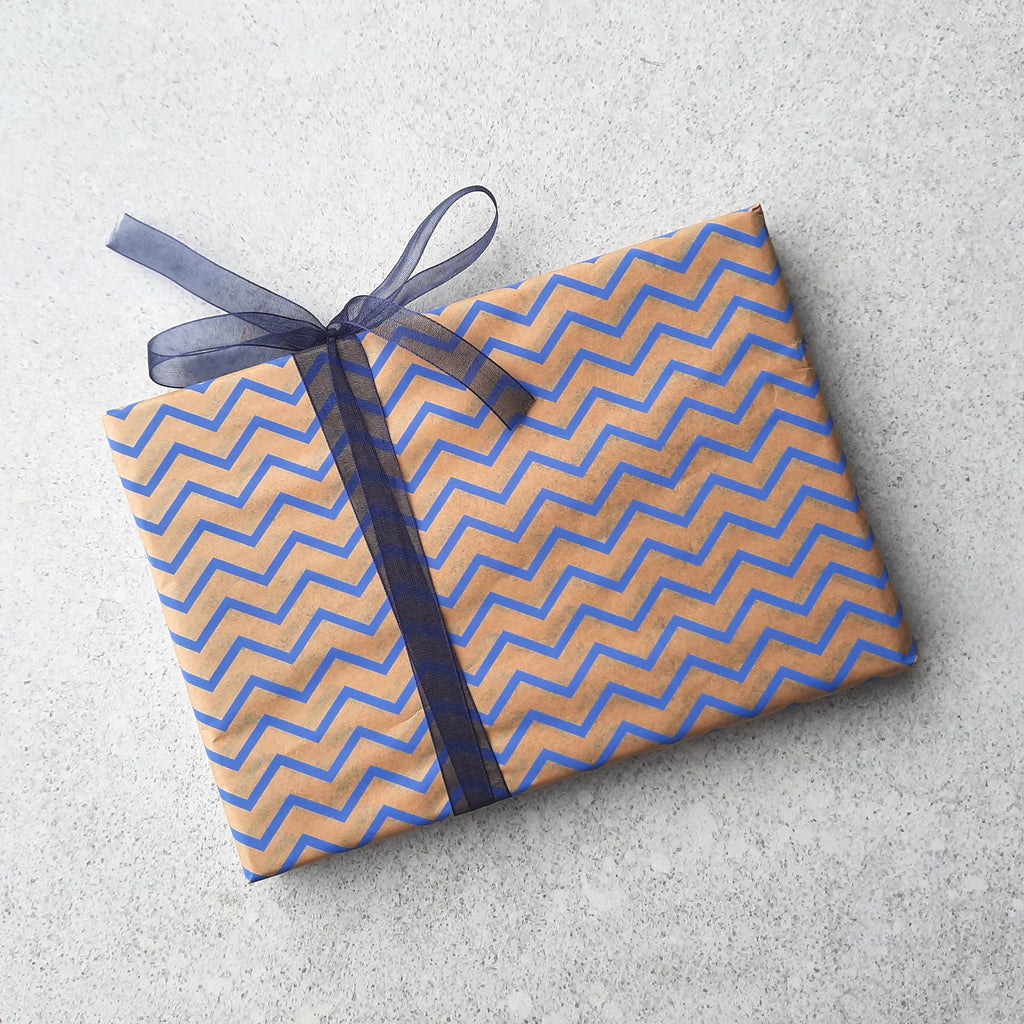 Our standard Bagstock & Bumble kraft gift wrap with a blue chevron design and blue ribbon