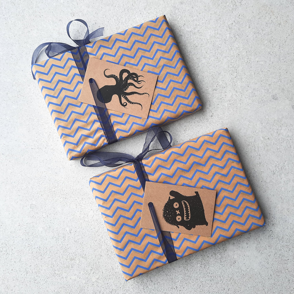 Blue and kraft brown gift wrap with blue ribbon and a choice of monster or octopus gift tags