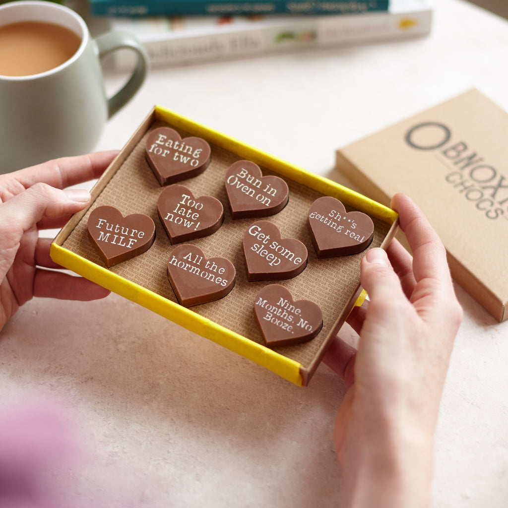 Eight funny pregnancy chocolate hearts presented in their custom Obnoxious Chocs gift box
